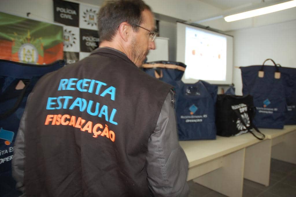 Agentes da Receita com os documentos apreendidos que foram lacrados em sacos